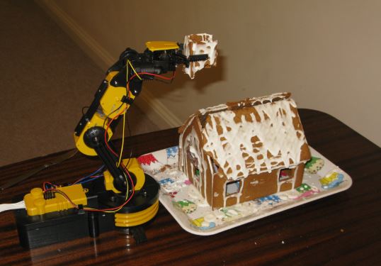 J beslutade att vi kunde hugga in på pepparkakshuset innan det blev för dammigt och mögligt (själv vägrar han smaka). Robotarmen som A fick i julklapp (och som han och jag hjälptes åt att skruva ihop) fick vara med i rivningen. 